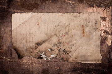 Old ragged paper sheet on a dark background