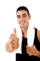 Beautiful fitness instructor doing thumbs up