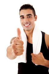 Beautiful fitness instructor doing thumbs up
