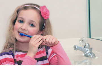 Cute Little Girl Happily Brushing Her Teeth