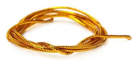 Naklejka premium Golden rope over white background