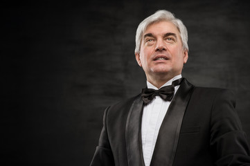 Fototapeta premium Portrait of a successful mature business man smiling - Copyspace
