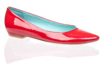 Red patent leather pump over white background