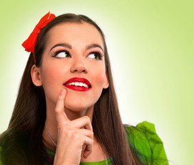 Portrait of a beautiful woman in green thinking