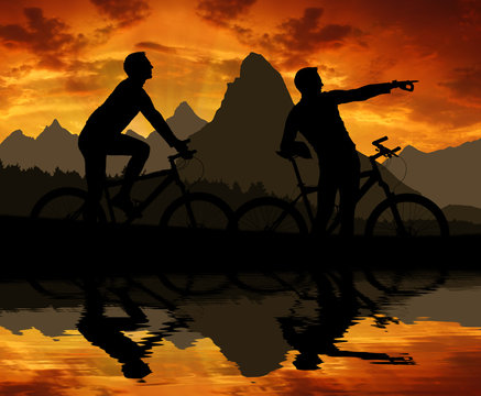 mountain bikers silhouette in sunset