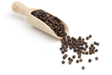 black peppercorns on a wooden scoop
