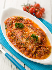 fish fillet with tomato sauce, selective focus