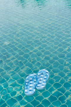 blue fish paint flip-flop floating in the pool