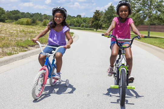 Happy African American Girls Riding Bikes