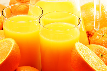 Composition with two glasses of orange juice and fruits