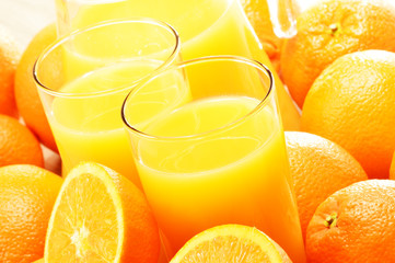 Composition with two glasses of orange juice and fruits