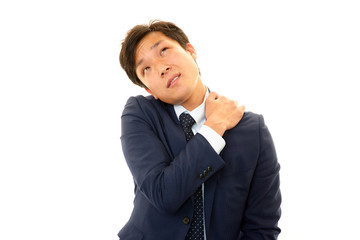 肩こりを訴えるビジネスマン