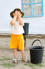 Cute little boy covering his face