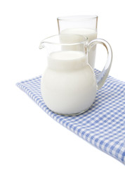 Obraz na płótnie Canvas A Glass of milk on plaid towel, isolated on the white.A Glass of