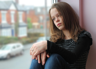 Stunning portrait of a young girl gazing out of the window