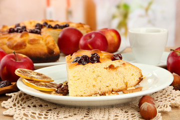 slice of tasty homemade pie with jam and apples and cup of