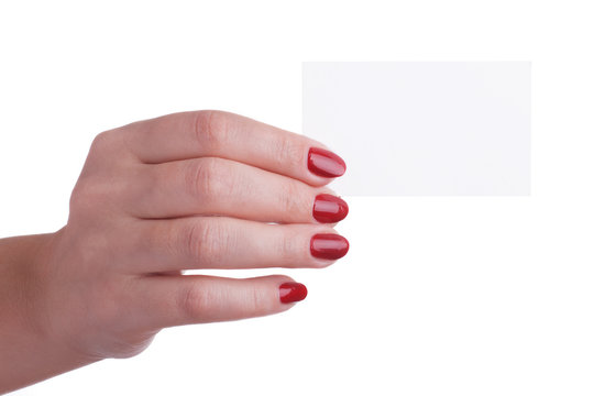 Female hand with red manicure holding a business card