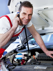 Car mechanic calls a customer to tell him the repair costs