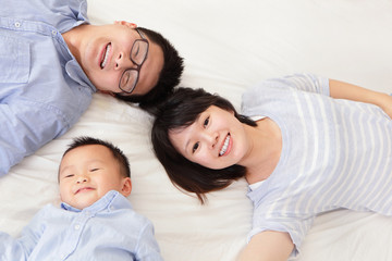Fototapeta na wymiar Happy family with children in bed