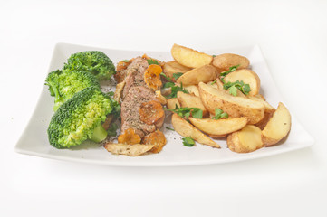 Tasty dinner - roast veal with fried potatoes and broccoli isola