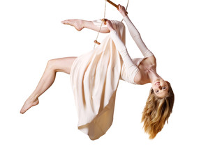 Young woman gymnast  on rope-ladder