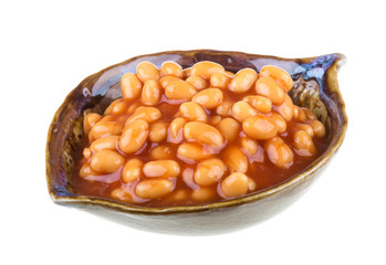 Marinated haricot beans in tomato sauce with shallots on a plate
