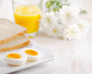 Boiled egg, toasts and orange juice.
