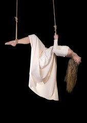 Young woman gymnast in white dress on rope