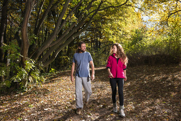 Fototapeta premium pair walking trough woods