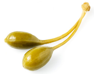 Close-up shot of two marinated capers  isolated on white