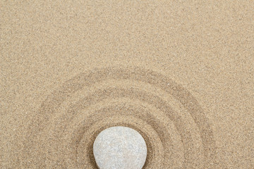 Fototapeta na wymiar zen stone in sand with circles