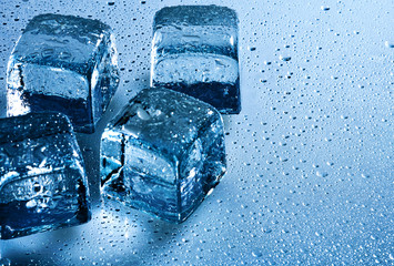 Ice cube and water drops on the wet background