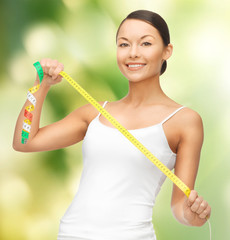 Fototapeta premium woman measuring her hips