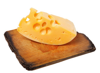 Piece of cheese on old wooden board