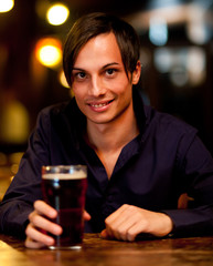 Man drinking a beer in a pub