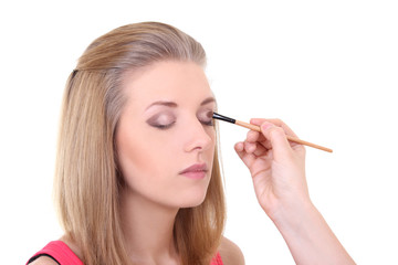 Fototapeta premium beautiful girl with make-up brush over white