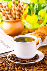 Coffee cup with fresh coffe beans for breakfast