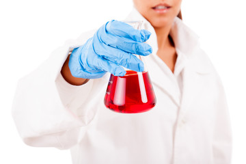 Fototapeta premium Young female scientist holding a tube of liquid