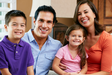 Obraz premium Portrait Of Family Sitting On Sofa At Home