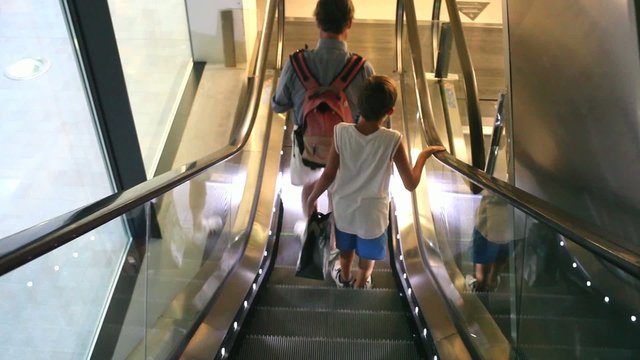 Father and son in the escalator