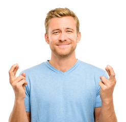 Young man making a wish isolated on white background