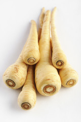 Parsnip on a white background, selective focus.