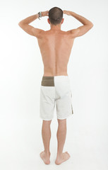 Rear view of man in swimming trunks looking far