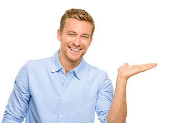 Happy young man showing empty copyspace on white background