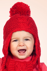Baby girl with a funny wool red hat