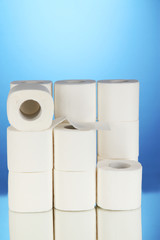Rolls of toilet paper on blue background