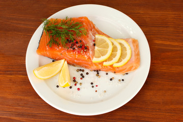 Fresh salmon fillet with herbals and lemon slices
