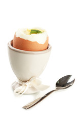 Boiled egg in egg cup, isolated on white