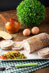 Meat roulade stuffed with egg, ham and vegetables