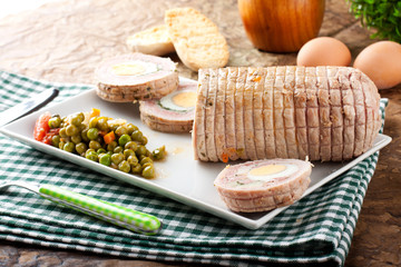 Meat roulade stuffed with egg, ham and vegetables